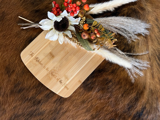 “The kitchen is the heart of the home” cutting board